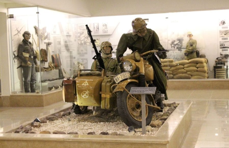 Dioramas and a World War II-era military motorcycle with a sidecar, manned by mannequins, are displayed Inside the El Alamein War Museum in Egypt.