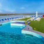 The inviting sundeck of the Solaris I Nile Cruise, featuring a sparkling swimming pool, comfortable loungers, and expansive views of the Nile River.