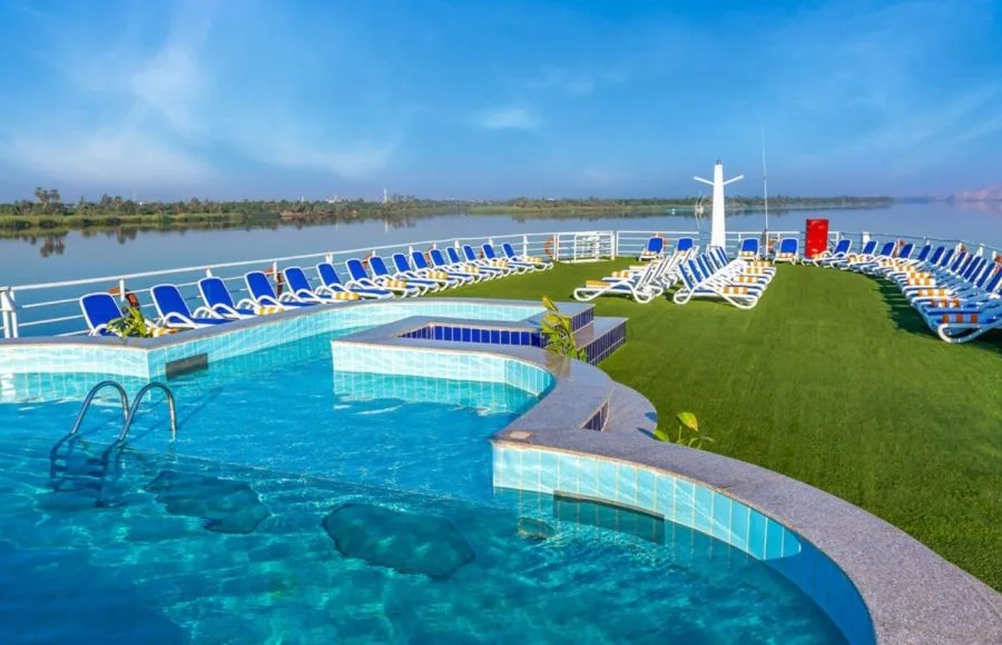 The inviting sundeck of the Solaris I Nile Cruise, featuring a sparkling swimming pool, comfortable loungers, and expansive views of the Nile River.