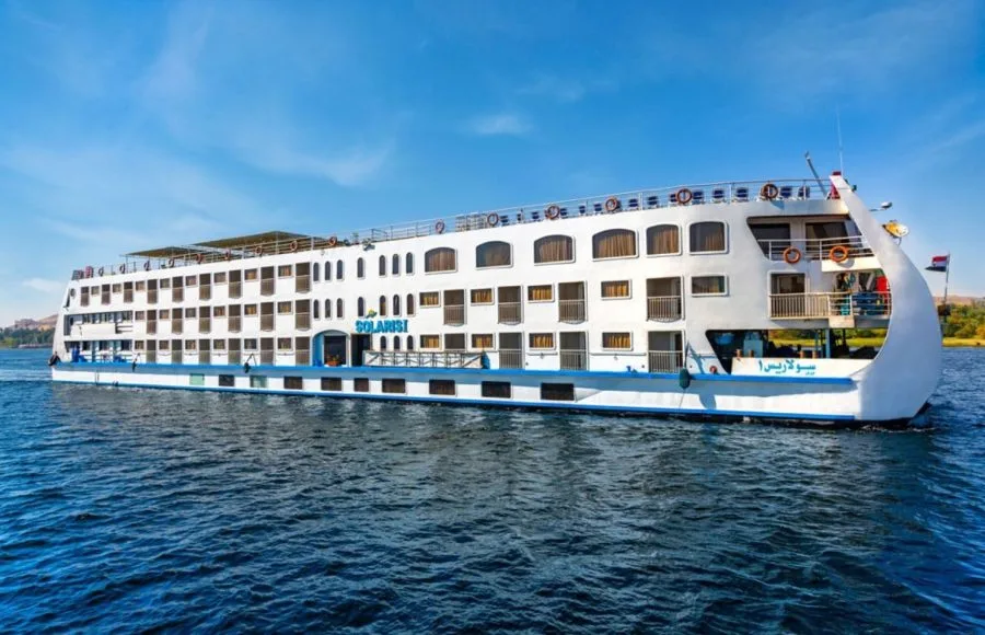 The majestic HS Solaris I Nile Cruise ship gracefully sailing on the Nile River under a clear blue sky, showcasing its elegant exterior.