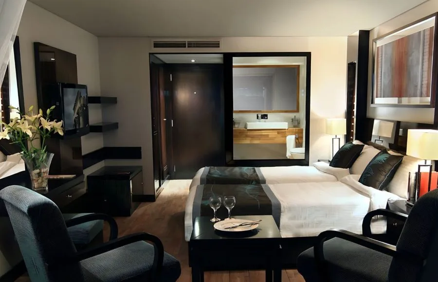 Bright twin-bedded cabin on MS Le Fayan with a river view window.