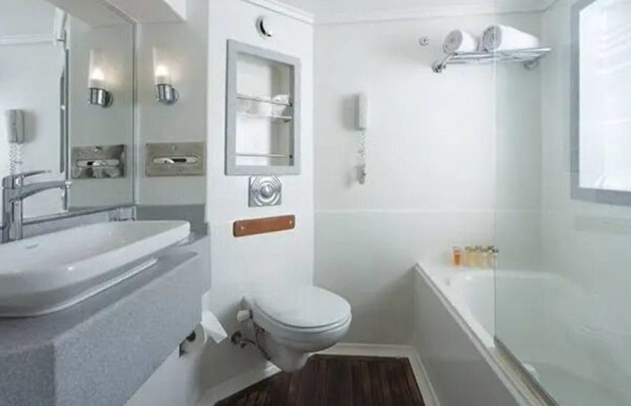 MS Acamar Nile Cruise standard cabin bathroom with a bathtub and shower.