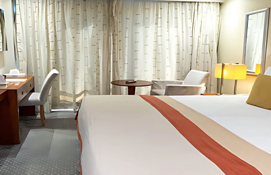 Relax in the comfortable cabin aboard the MS Al Jamila Nile Cruise ship, featuring cozy bedding and a pleasant ambiance