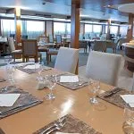 A beautifully set table awaits diners in the spacious restaurant of the Sabena Al Jamila Nile Cruise