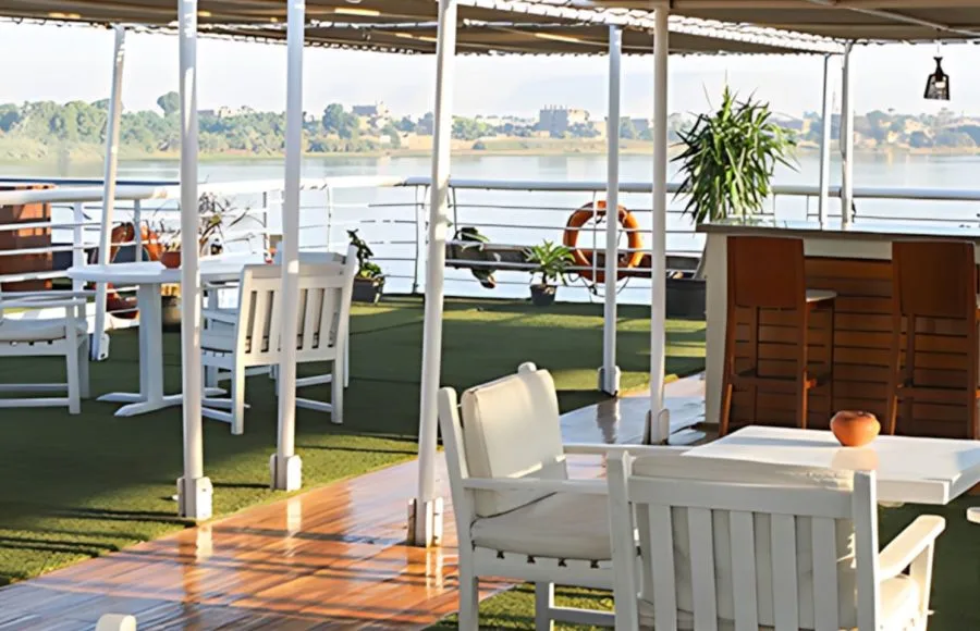 Enjoy the stunning views from the sun deck of the MS Al Jamila Nile Cruise, featuring a swimming pool and lounge chairs