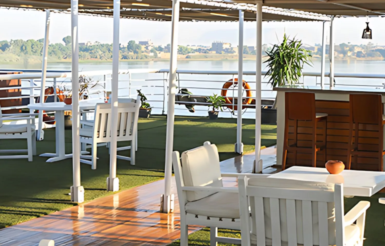 Enjoy the stunning views from the sun deck of the MS Al Jamila Nile Cruise, featuring a swimming pool and lounge chairs