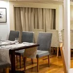 The elegant dining room on the Al Kahila Nile cruise, featuring beautifully set tables and comfortable seating.