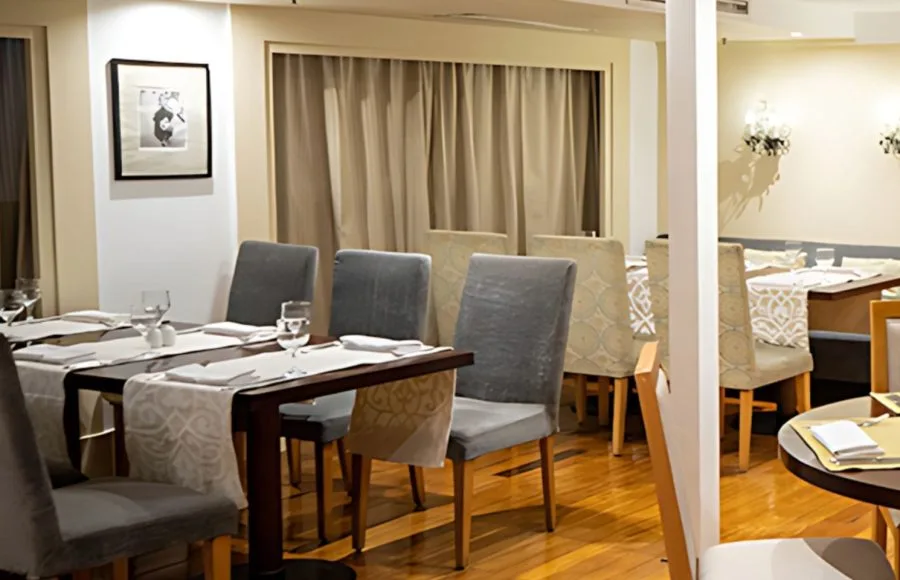 The elegant dining room on the Al Kahila Nile cruise, featuring beautifully set tables and comfortable seating.