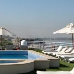 Relax aboard the luxurious Al Kahila Nile cruise ship with stunning deck views, a sparkling pool, and comfortable sun loungers perfect for soaking up the Egyptian sun.