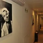 An elegant corridor on the MS Alexander The Great Nile Cruise ship, featuring a large black and white framed photo and wood accents.