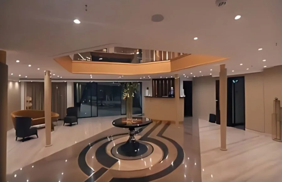 The lobby of the MS Concerto II, with a reception desk and stylish seating areas.