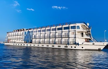 A beautiful side view of the MS Concerto II Nile Cruise ship sailing on the river.