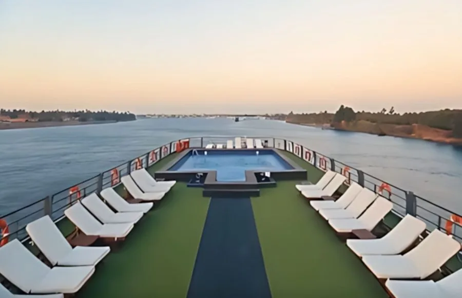 The sun deck of the MS Concerto II with a swimming pool surrounded by sun loungers.