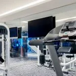 The modern onboard gymnasium of the Movenpick MS Darakum Nile Cruise features cardiovascular and strength training equipment including a treadmill and weight machine for guest use