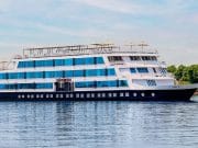 The elegant exterior of the Movenpick MS Darakum Nile Cruise prominently displays the Movenpick logo with multiple decks of cabins and a sunny top deck for leisure