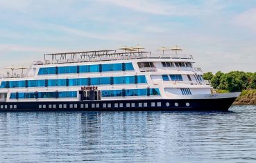 The elegant exterior of the Movenpick MS Darakum Nile Cruise prominently displays the Movenpick logo with multiple decks of cabins and a sunny top deck for leisure