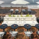 The inviting outdoor lounge area of the Movenpick MS Darakum Nile Cruise offers stylish seating and shaded tables perfect for enjoying the views and socializing on the Nile