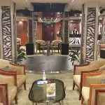 Ship lounge and bar area with a dance floor and plush seating.