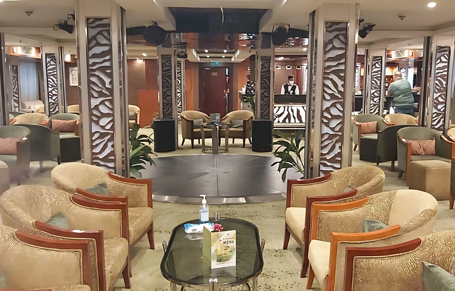 Ship lounge and bar area with a dance floor and plush seating.