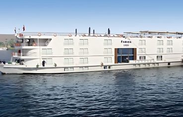 The elegant MS Farida Nile Cruise sails on the serene Nile River, a stunning view of the boat that promises a luxurious and memorable journey.