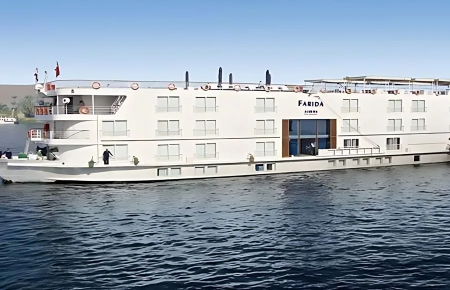 The elegant MS Farida Nile Cruise sails on the serene Nile River, a stunning view of the boat that promises a luxurious and memorable journey.