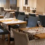 The elegant dining room of the MS Farida Nile Cruise is set with tasteful decor, ready to offer guests a delightful culinary experience.