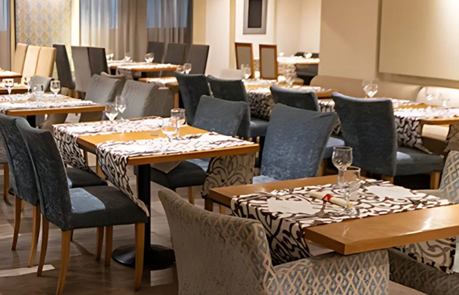 The elegant dining room of the MS Farida Nile Cruise is set with tasteful decor, ready to offer guests a delightful culinary experience.