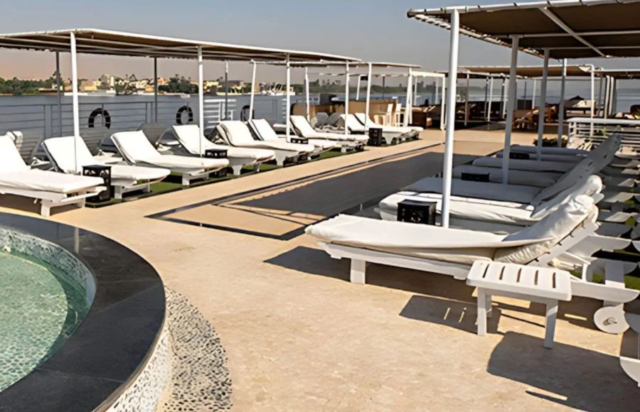 Relax by the sparkling pool on the spacious sun deck of the MS Farida Nile Cruise, offering comfortable loungers and refreshing shade for ultimate enjoyment.