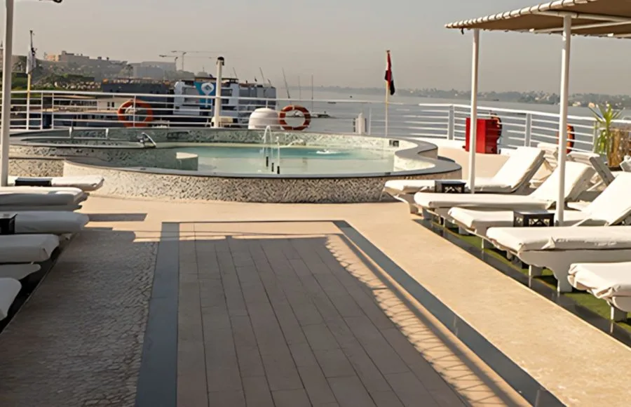 Ms Farida Nile cruise sun deck with a sparkling pool and luxurious loungers, offering stunning views along the Nile.