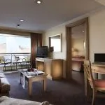 Suite on the Iberotel Crown Emperor Nile Cruise with a living area and balcony.