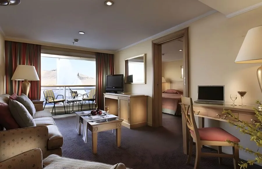 Suite on the Iberotel Crown Emperor Nile Cruise with a living area and balcony.