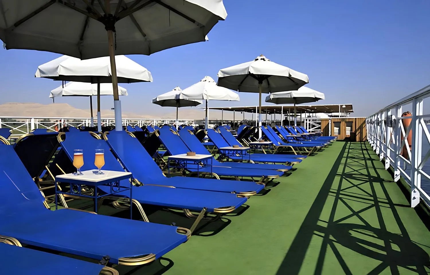 Sun deck with blue loungers on the Iberotel Crown Emperor Nile Cruise.
