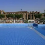 Swimming pool on the Iberotel MS Crown Empress with a view of an ancient temple.