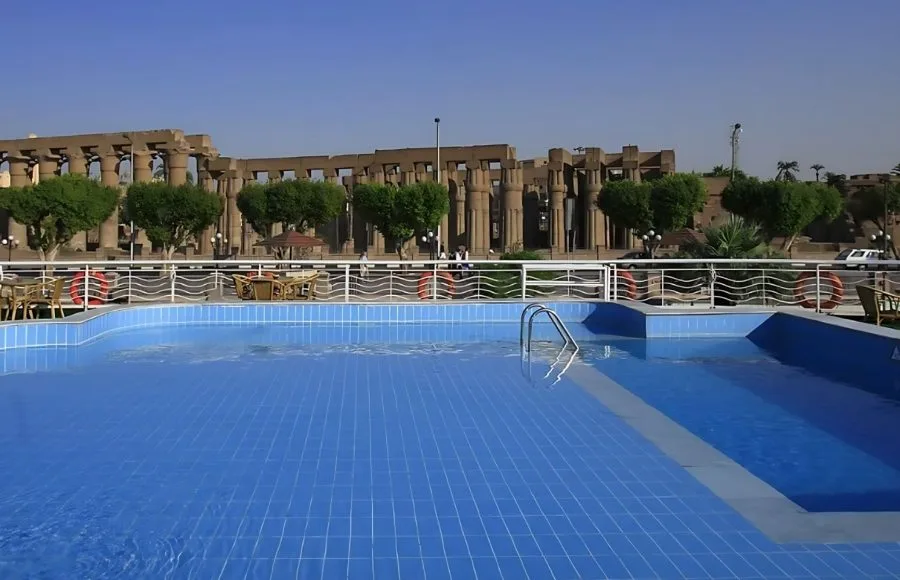 Swimming pool on the Iberotel MS Crown Empress with a view of an ancient temple.