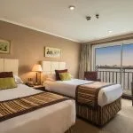 Cabin with twin beds and a river view on the MS Jaz Crown Jewel.