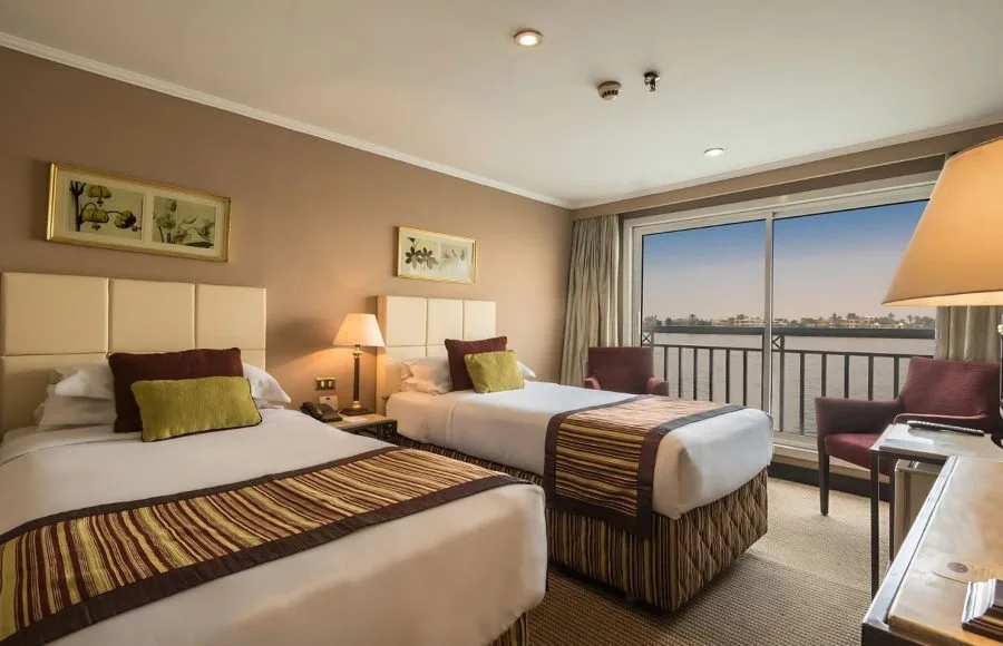 Cabin with twin beds and a river view on the MS Jaz Crown Jewel.