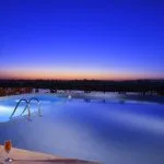 The illuminated pool on the Jaz Nile Monarch after sunset.