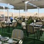 The sun deck on the Jaz Nile Monarch with seating and a view of the river.