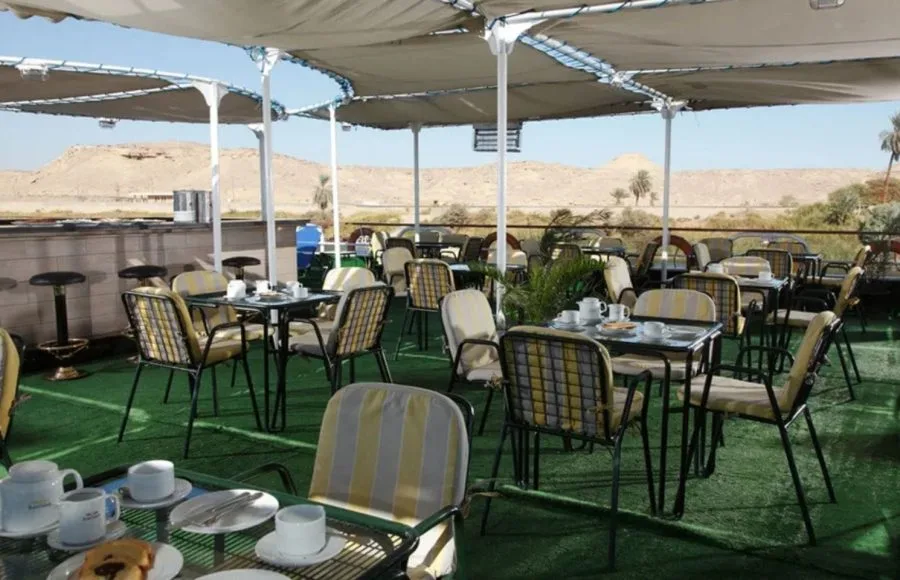 The sun deck on the Jaz Nile Monarch with seating and a view of the river.