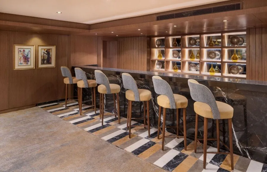 A modern and stylish bar on the MS Jaz Regent Nile Cruise, with high chairs and a sophisticated decor.