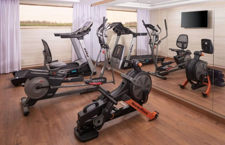 The well-equipped gymnasium on the MS Jaz Regent Nile Cruise, featuring treadmills, elliptical machines, rowing machines, and a stationary bike.