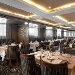 The elegant and spacious restaurant on the MS Jaz Regent Nile Cruise, with multiple dining tables set for guests.