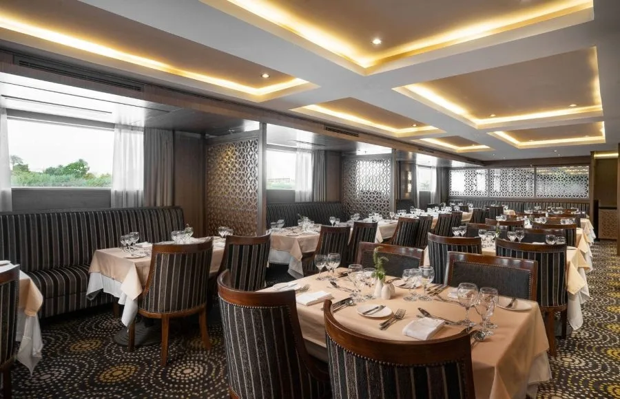 The elegant and spacious restaurant on the MS Jaz Regent Nile Cruise, with multiple dining tables set for guests.