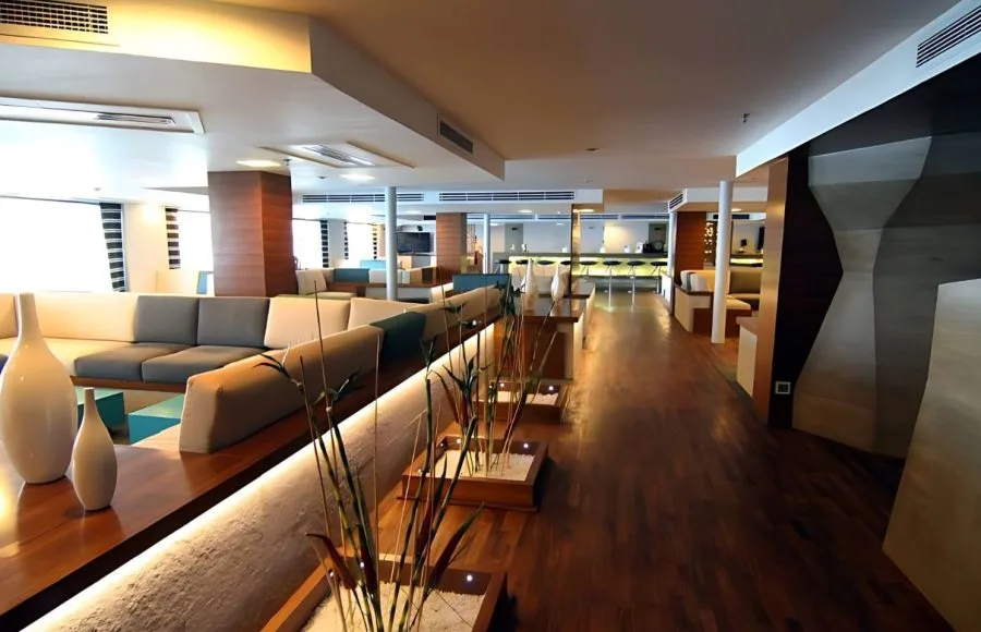 The main lounge on MS Le Fayan, featuring, comfortable sofas, and a bar area.