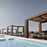 The sun deck on MS Le Fayan showing the swimming pool and modern lounge chairs.