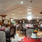 Spacious dining area inside the MS Medea Nile Cruise restaurant with set tables