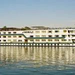 The classic white exterior of the MS Medea Nile Cruise ship sailing on the river