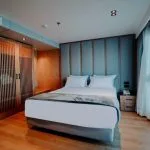 A comfortable and modern cabin on the MS Miriam Nile Cruise featuring a cozy bed and large window with a river view