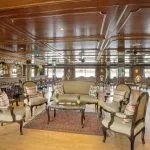 The classic wood-paneled upper lounge and bar with traditional furnishings aboard the MS Miriam nile cruise ship