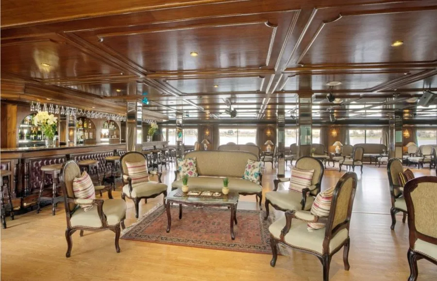 The classic wood-paneled upper lounge and bar with traditional furnishings aboard the MS Miriam nile cruise ship